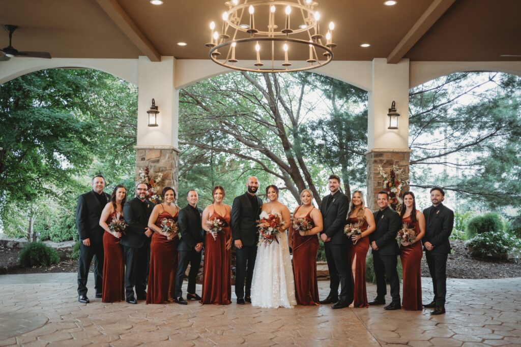 Covered patio with stone and waterfall, trees and rain back up