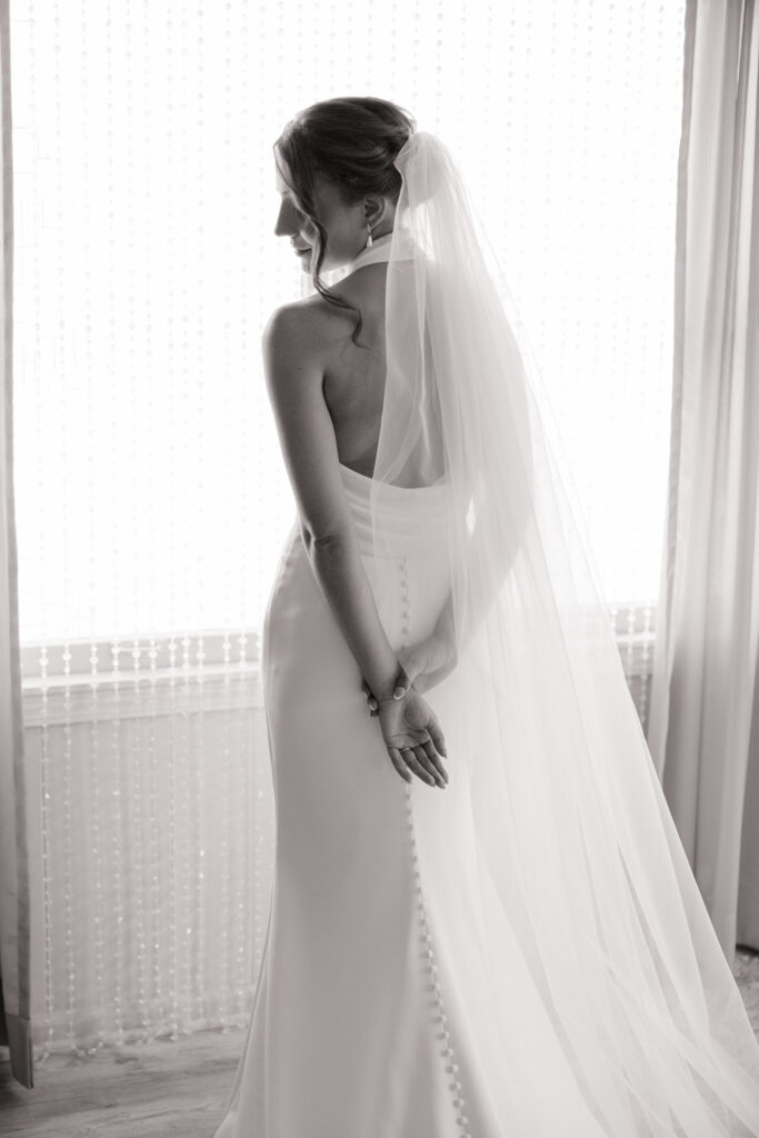 timeless and classy wedding. bride in bridal suite, in bridal dress and veil, natural lighting wedding