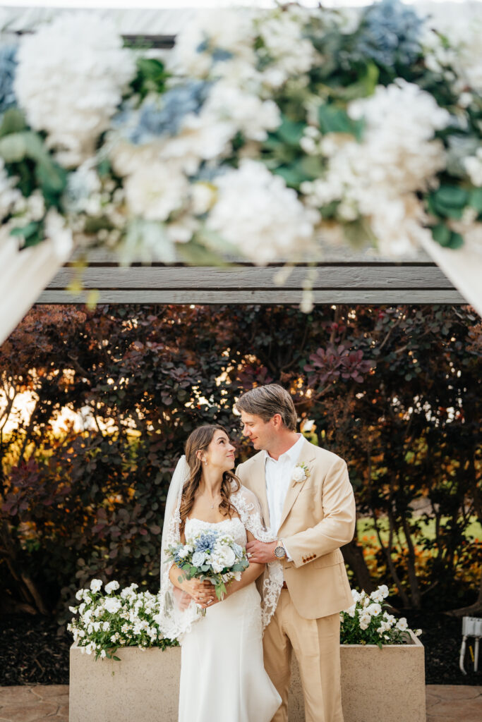 bride and groom on wedding day at outdoor venue with indoor reception and rain back up plan b, romantic in love photography, bridal flowers, garden flowers